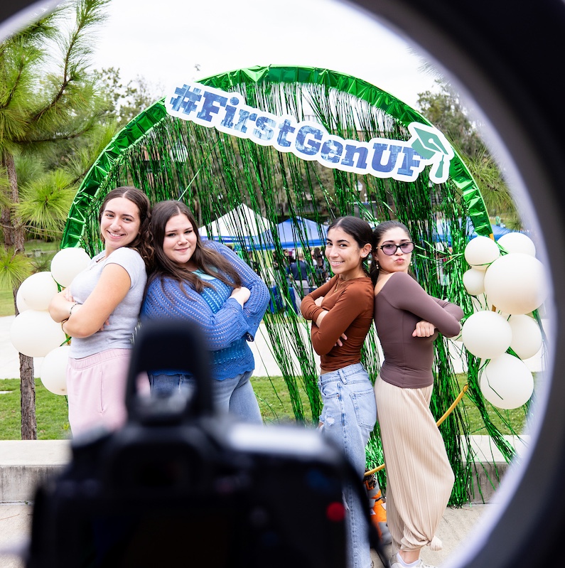 Four students pose at the First Gen Picnic photobooth.