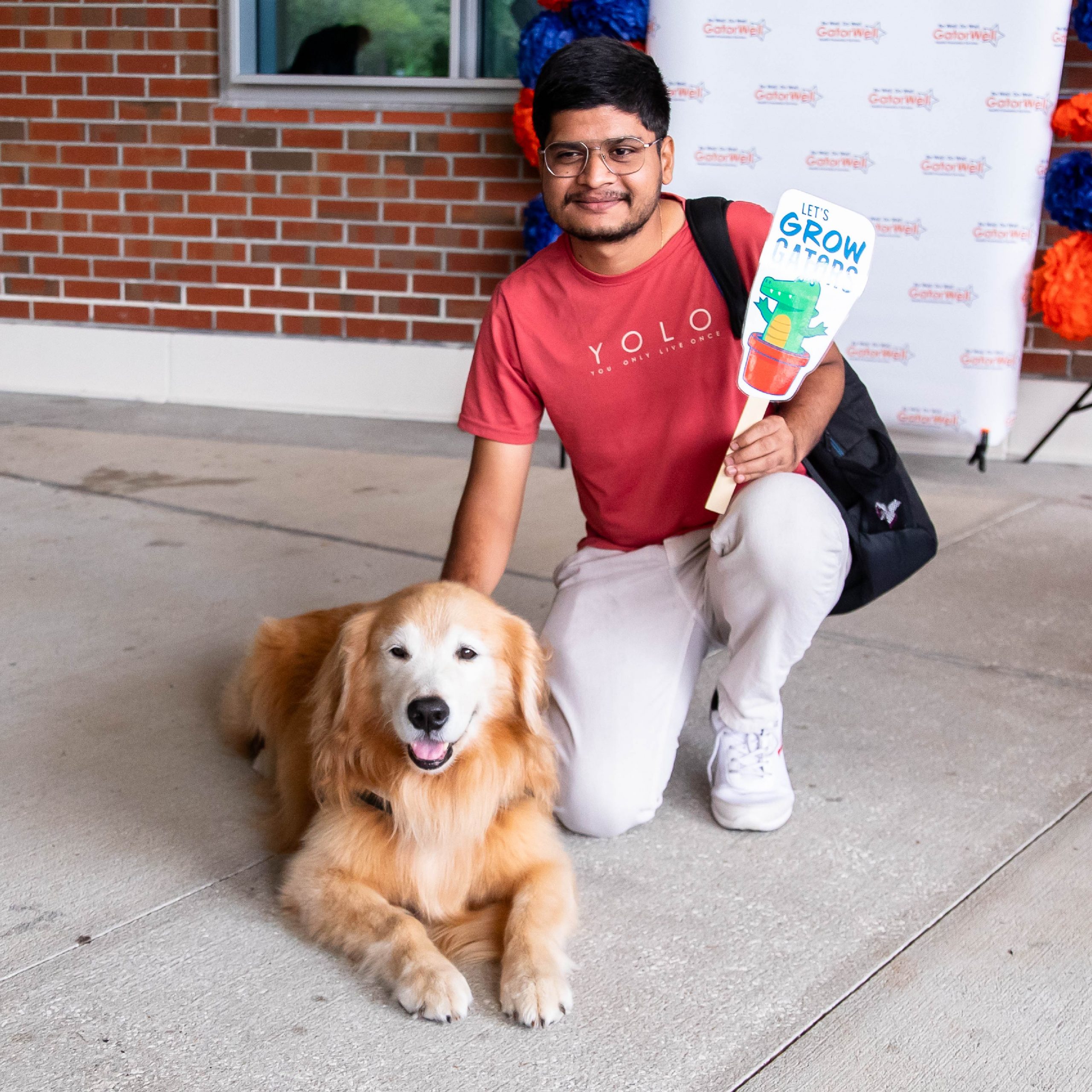 A student interacting with a dog.